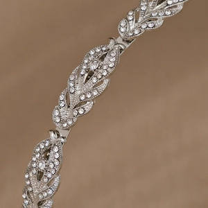 Macro shot of silver alloy wheat leaf headband with sparkling rhinestones for bridal hair