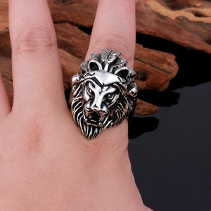 Close-up of a punk-style silver lion head ring showing intricate relief details on a model