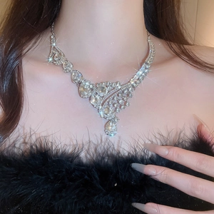Close-up of sparkling teardrop crystal necklace on model for elegant court style