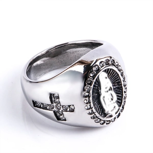Detailed macro view of hiphop ring featuring Virgin Mary relief and cross with white stones
