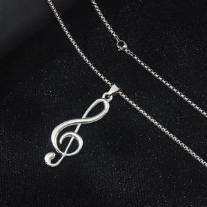 Minimalist silver stainless steel treble clef musical note necklace on box chain