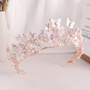 Detailed macro view of crystal butterfly crown with pink petals and pearls on rose gold