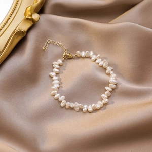 Baroque irregular pearl bracelet with gold adjustable chain on champagne silk