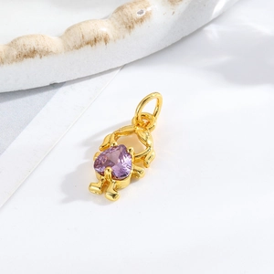 Macro shot of gold girl pendant with purple heart zirconia for DIY jewelry making