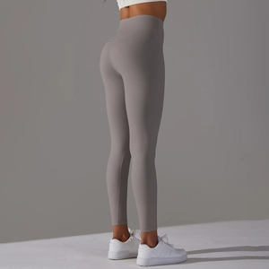 Close-up of high-waist taupe yoga leggings showing lifting effect and seamless fabric texture