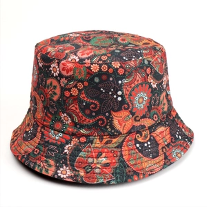 Detail of double-sided bucket hat with vibrant paisley floral print and durable fabric