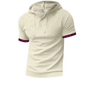 Detail of waffle knit fabric on men's beige hooded polo shirt with plaid sleeve cuffs