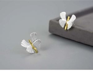 Macro shot of S925 sterling silver butterfly earrings with brushed gold and silver finish