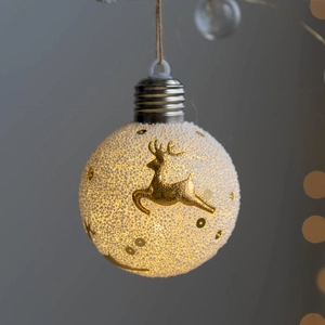 Luminous Christmas ball ornament with reindeer motif and sparkling snow texture