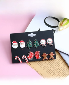 Detail view of 6-pair Christmas stud earrings set featuring Santa, tree, and snowman