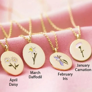 Gold-plated vintage floral birth flower necklaces for January to April on pink velvet