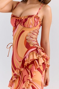 Detail of vibrant swirl print dress featuring side cut-outs and ruffled edges