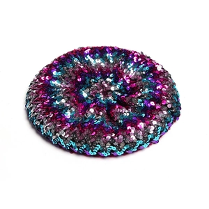 Detailed close-up of vibrant purple and blue sequins on a stylish beret hat for women