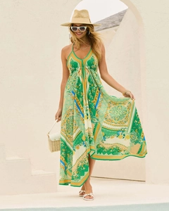Detail of bohemian floral print maxi dress featuring halter neck and asymmetric hem