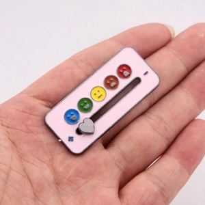Macro view of a pink enamel interactive mood slider pin with heart-shaped metal pointer