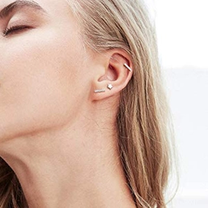 Close-up of minimalist S925 silver stud earring set with star and bar designs