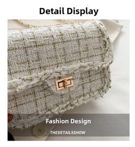 Close-up of elegant cream tweed texture with gold metallic threads and metal clasp