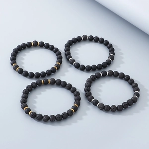 Set of four handmade black onyx and lava stone beaded bracelets with metallic spacer beads
