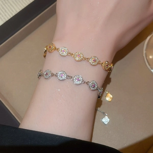 Detailed view of 18K gold and silver plated round bracelets featuring sparkling zircons