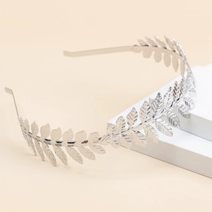 Elegant silver leaf headband in alloy metal for women displayed on white platform