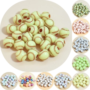 Close-up of assorted acrylic sports beads including baseball and tennis ball styles for DIY