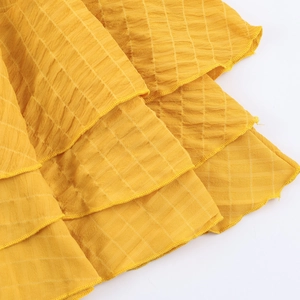 Abito giallo in tessuto nido d'ape con volant a strati e scollo a V con laccio