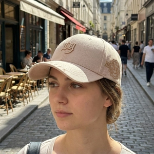 Outdoor lifestyle shot of a beige baseball cap with 3D embroidery and side patches