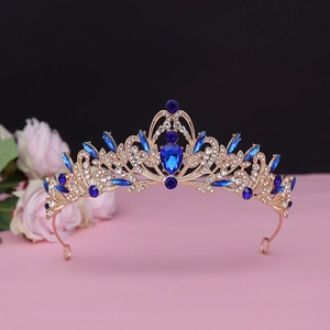 Detailed view of luxury baroque bridal crown with deep blue crystals and gold filigree