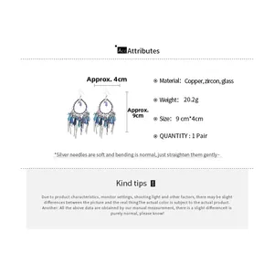 Detail of bohemian water drop earrings with blue crystal tassels and silver needles