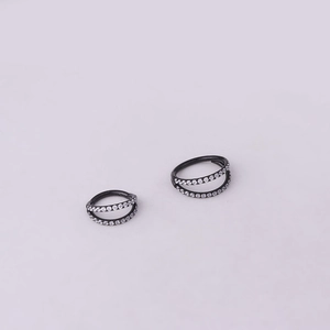 Close-up of black stainless steel seamless rings with double rows of sparkling zircon stones