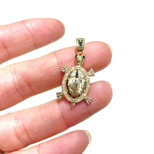 Golden sea turtle pendant with sparkling cubic zirconia shell and black stone eyes