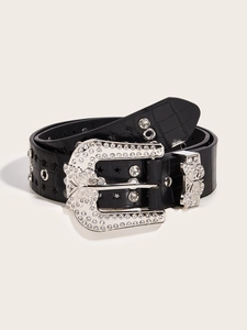 Detail of black crocodile texture belt with sparkling rhinestone butterfly buckle and star studs