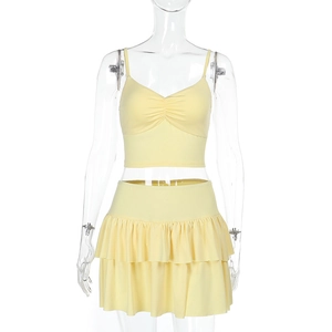 Detail of light yellow two-piece summer set with ruched camisole and layered ruffle skirt