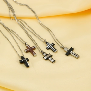 Cross necklaces with titanium steel and crystals on silk fabric background