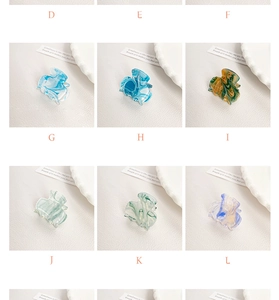 Detail view of mini acrylic hair claws with marble textures and color gradients