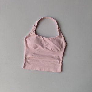 Detail of light pink square neck yoga tank top with seamless ribbed texture and chest pads