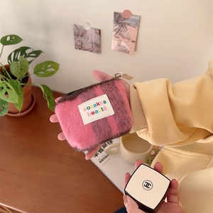 Close-up of pink checkered plush mini cosmetic bag with sozakka beauté label