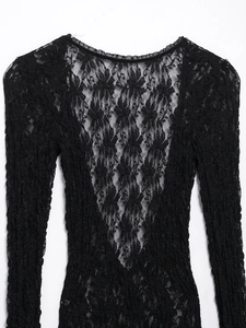 Detailed back view of a black lace long-sleeve dress with intricate floral patterns