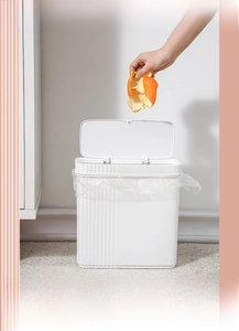Close-up of slim white trash can with large opening and vertical stripe texture for kitchens