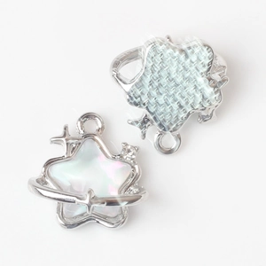 Detailed view of silver star and heart pendants with blue and white enamel for jewelry DIY