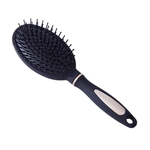 Spazzola per capelli con massaggio a cuscino d'aria nero e oro champagne su bianco