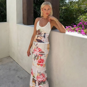 Detailed close-up of white knitted bodice and red floral print on the halter dress