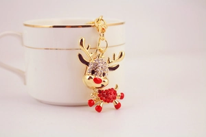 Close-up of golden reindeer keychain featuring sparkling clear and red rhinestones