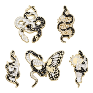 Set of 5 vintage enamel snake pins with sun moon and floral motifs in gold and black