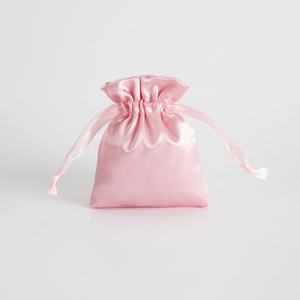 Detailed view of a pink satin drawstring jewelry pouch with smooth glossy finish