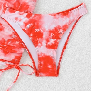 Detailed flat lay of red and white printed bikini set with drawstring and side ties