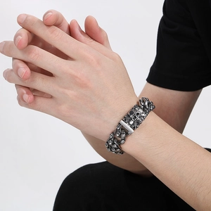 Men's retro skull bracelet in gothic punk style with antique silver finish on male wrist