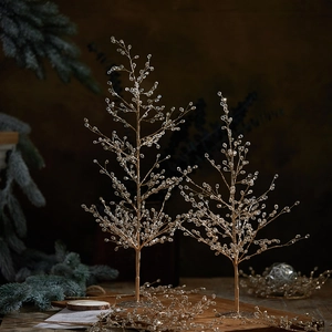Champagne gold acrylic Christmas tree decoration set with crystals on dark wood surface