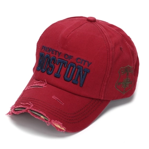 Close-up of distressed brim and Boston embroidery on wine red vintage baseball cap