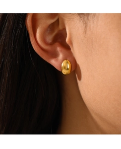 Detailed close-up of smooth 18K gold-plated oval stud earrings with polished finish